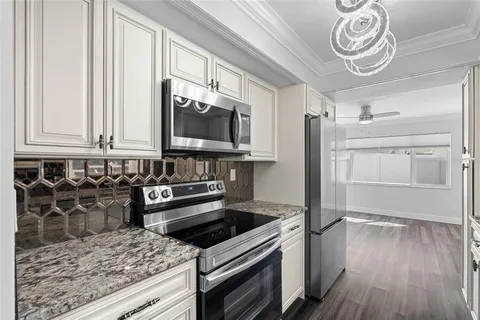 a kitchen with a refrigerator stove and microwave