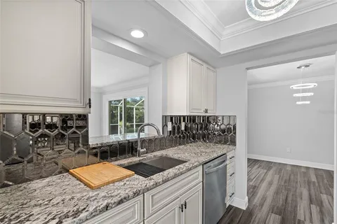 a kitchen with a sink and a stove next to a window