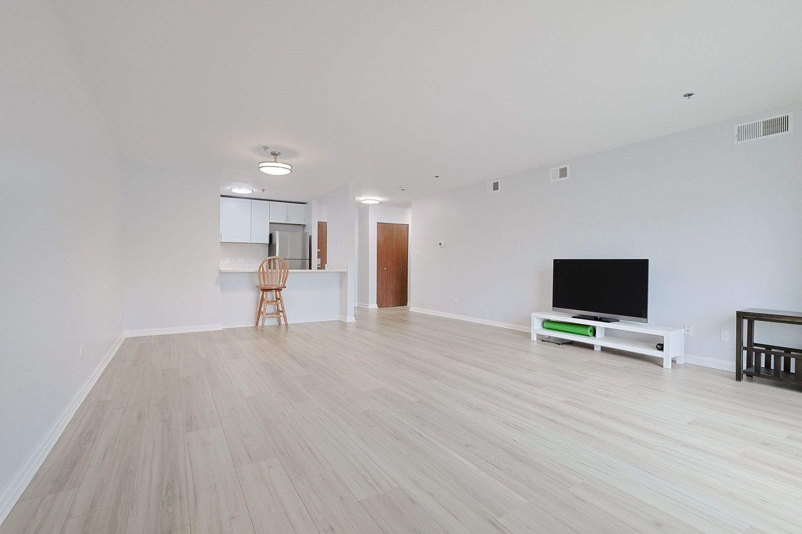 3265 Kirchoff Road, Unit 127 Rolling Meadows, IL 60008 - Photo 4 of 22 a view of empty room with wooden floor and working space