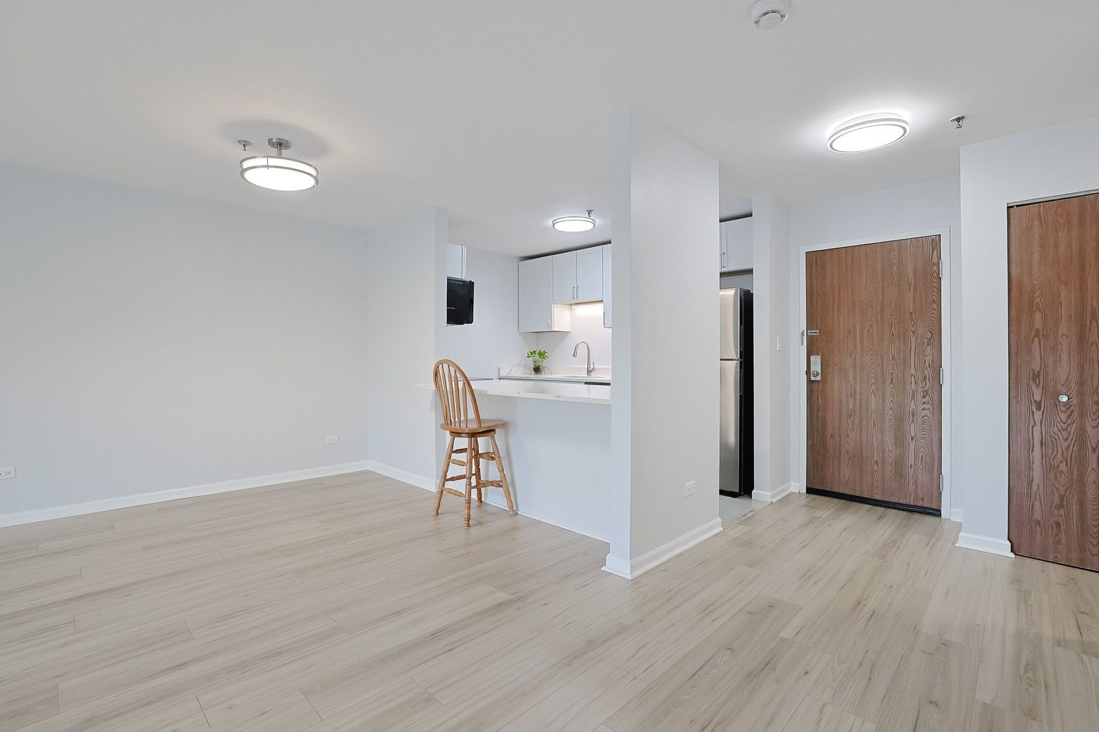3265 Kirchoff Road, Unit 127 Rolling Meadows, IL 60008 - Photo 6 of 22 a view of a kitchen with wooden floor and a sink