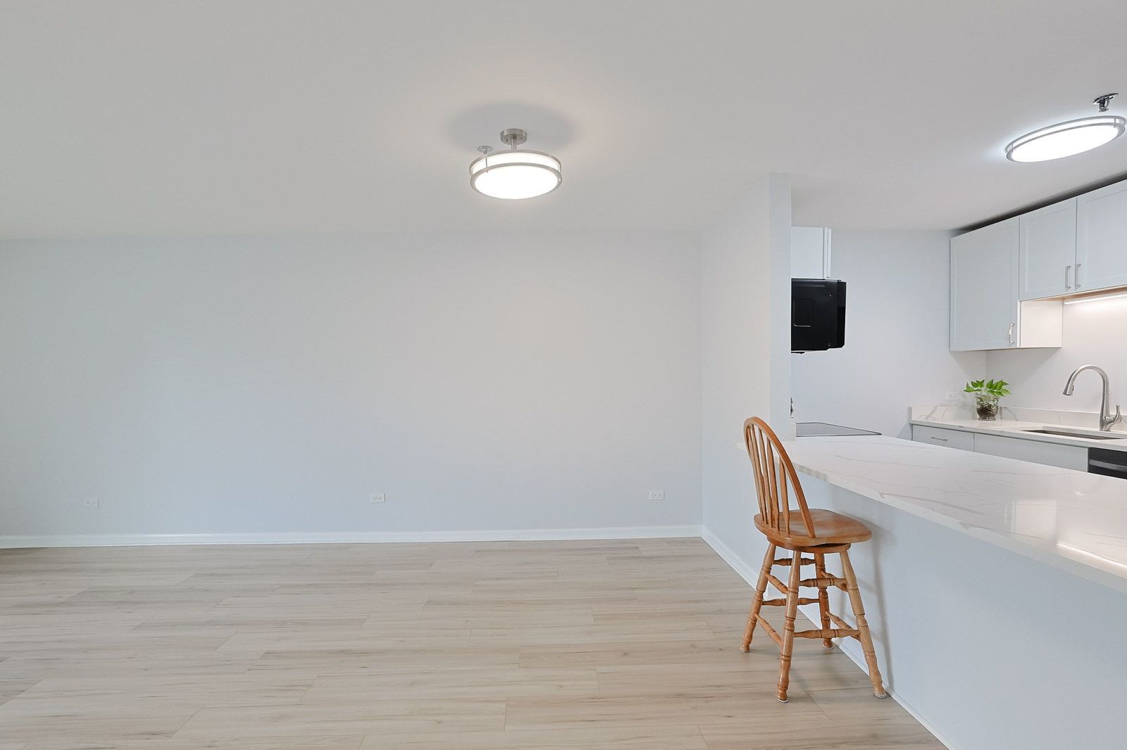 3265 Kirchoff Road, Unit 127 Rolling Meadows, IL 60008 - Photo 7 of 22 a view of a workspace with furniture and wooden floor