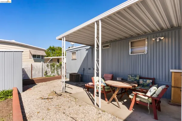 a backyard of a house with table and chairs