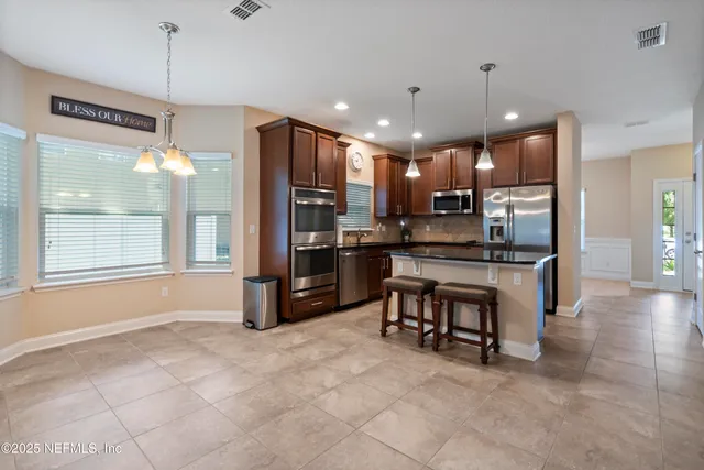 a spacious bedroom with a bed and a chandelier