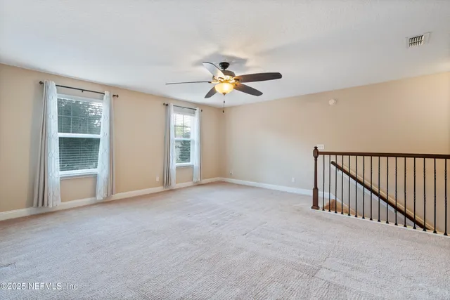 an aerial view of residential house with outdoor space and trees all around