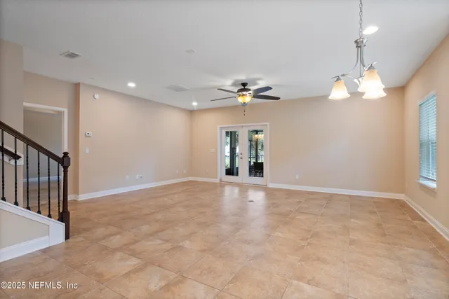 a kitchen with stainless steel appliances granite countertop a refrigerator a stove and a sink with wooden floor