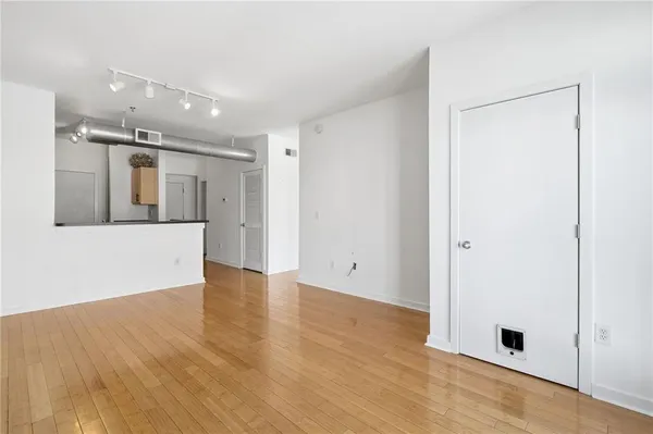 a kitchen with stainless steel appliances a refrigerator a sink a stove a microwave a counter space and cabinets