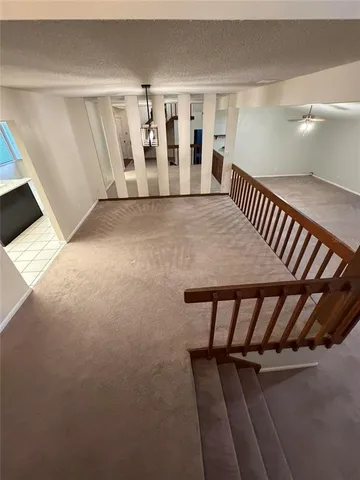 a view of an empty room with staircase