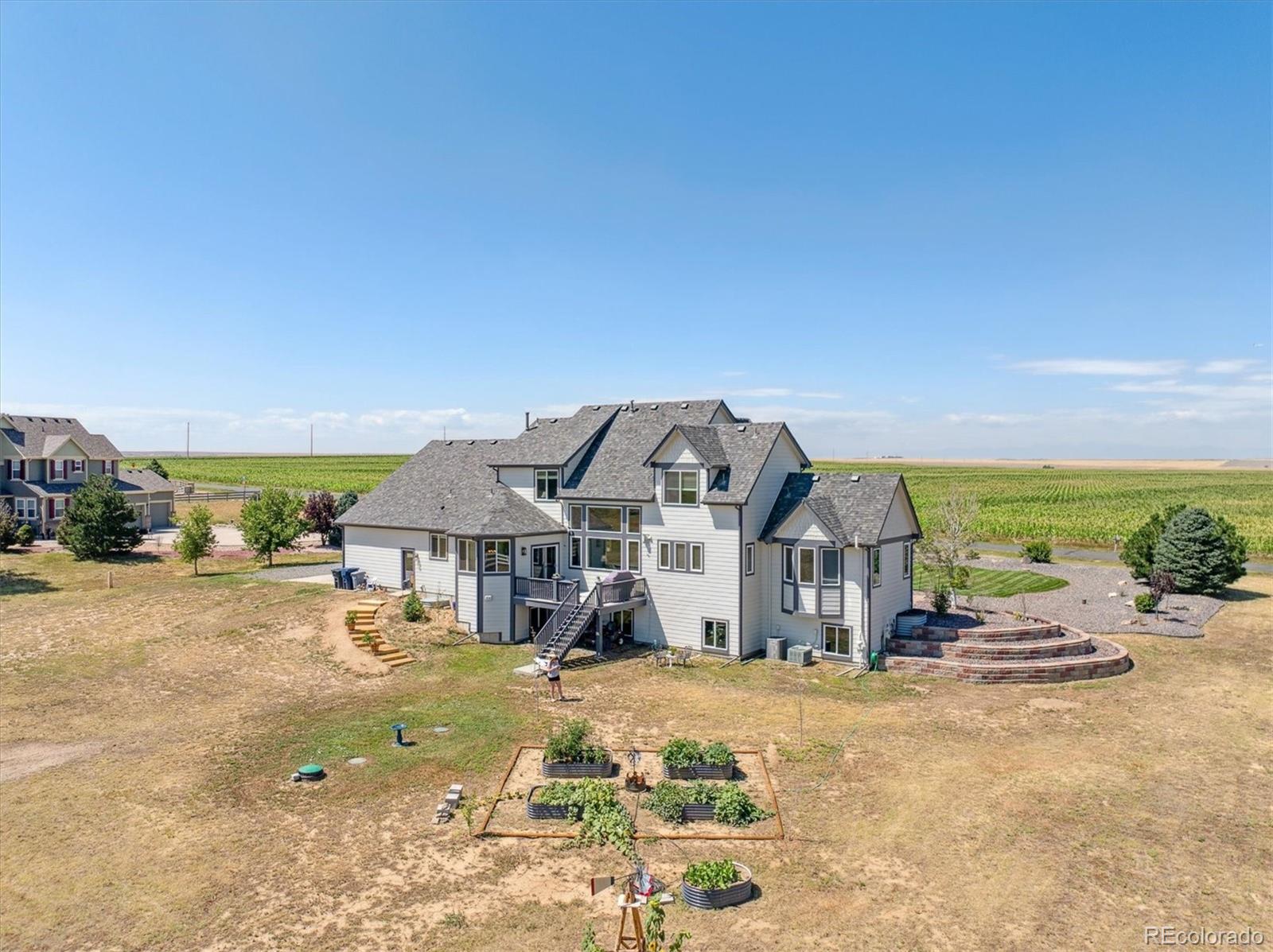 724 Imboden Road Watkins, CO 80137 - Photo 43 of 50 a view of a big house with a big yard and large tree s