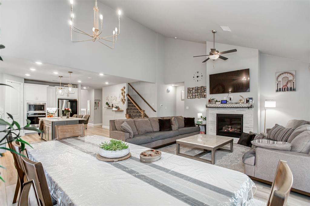 2437 Pinnacle Place Corinth, TX 76210 - Photo 14 of 40 a living room with furniture a fireplace and a flat screen tv