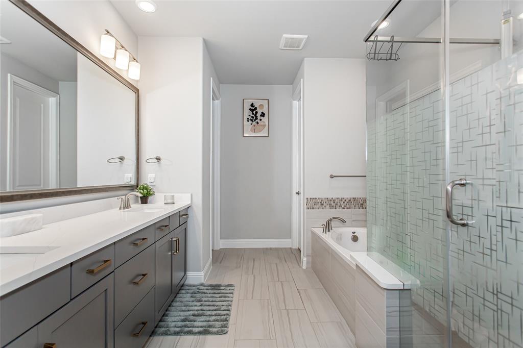 2437 Pinnacle Place Corinth, TX 76210 - Photo 22 of 40 a bathroom with a tub sink and mirror