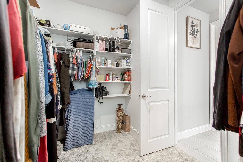 2437 Pinnacle Place Corinth, TX 76210 - Photo 23 of 40 a view of walk in closet with clothes and shoes