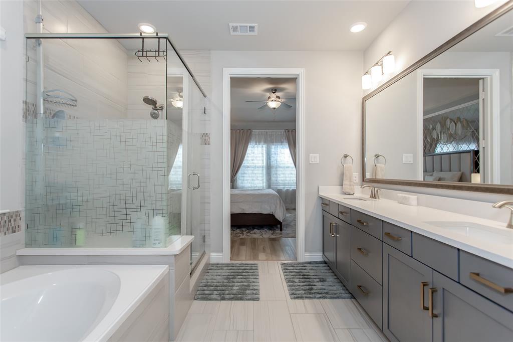 2437 Pinnacle Place Corinth, TX 76210 - Photo 24 of 40 a bathroom with a tub shower and sink