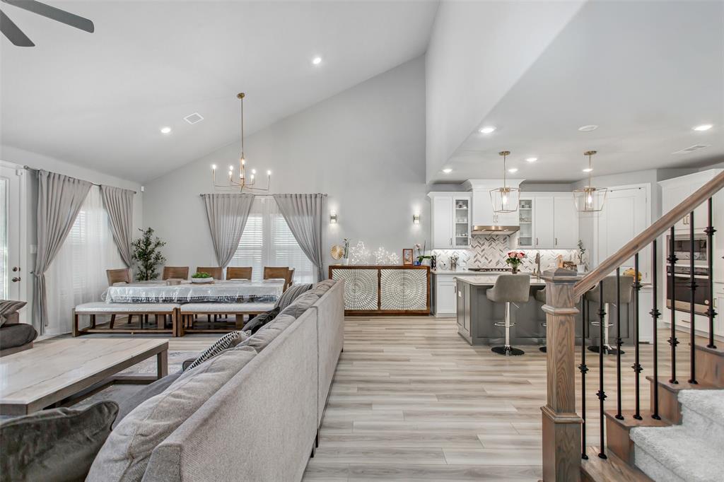 2437 Pinnacle Place Corinth, TX 76210 - Photo 25 of 40 a kitchen with stainless steel appliances kitchen island granite countertop a stove a sink and a refrigerator