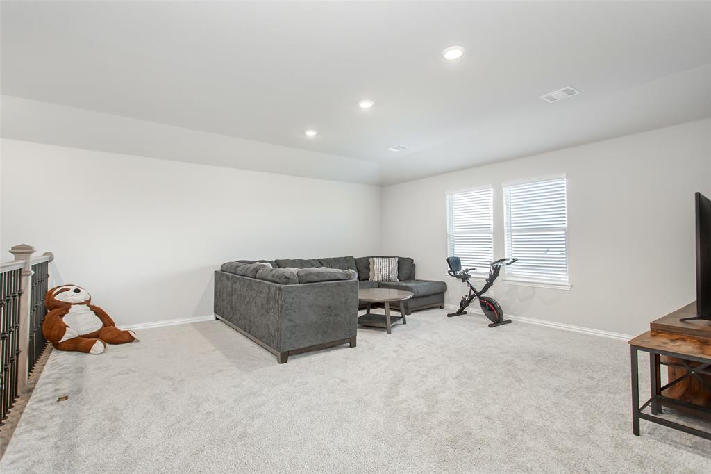 2437 Pinnacle Place Corinth, TX 76210 - Photo 26 of 40 a living room with furniture and a window