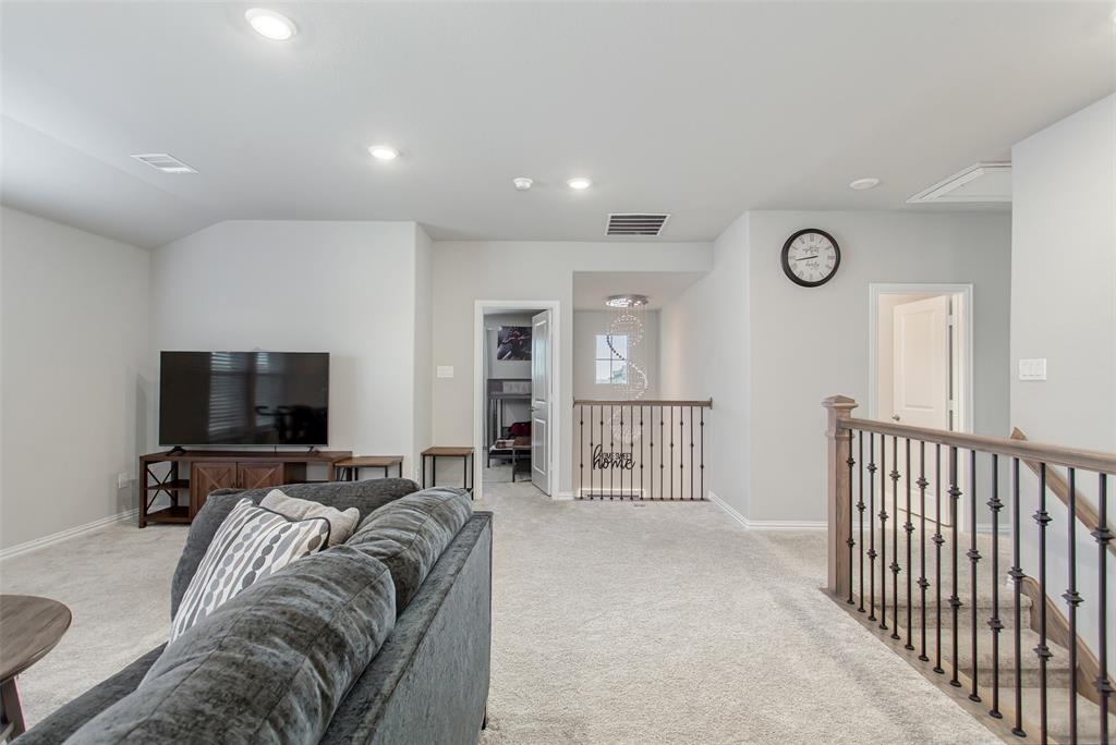 2437 Pinnacle Place Corinth, TX 76210 - Photo 27 of 40 a living room with furniture and a flat screen tv