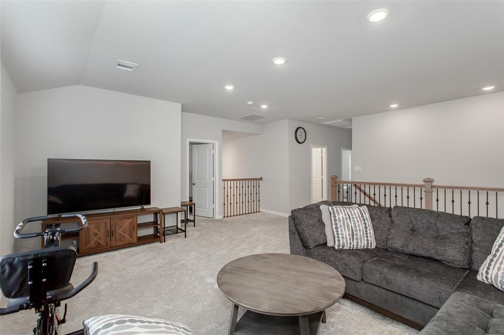 2437 Pinnacle Place Corinth, TX 76210 - Photo 29 of 40 a living room with furniture and a flat screen tv