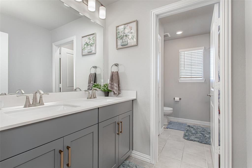 2437 Pinnacle Place Corinth, TX 76210 - Photo 32 of 40 a bathroom with a granite countertop sink mirror and a
