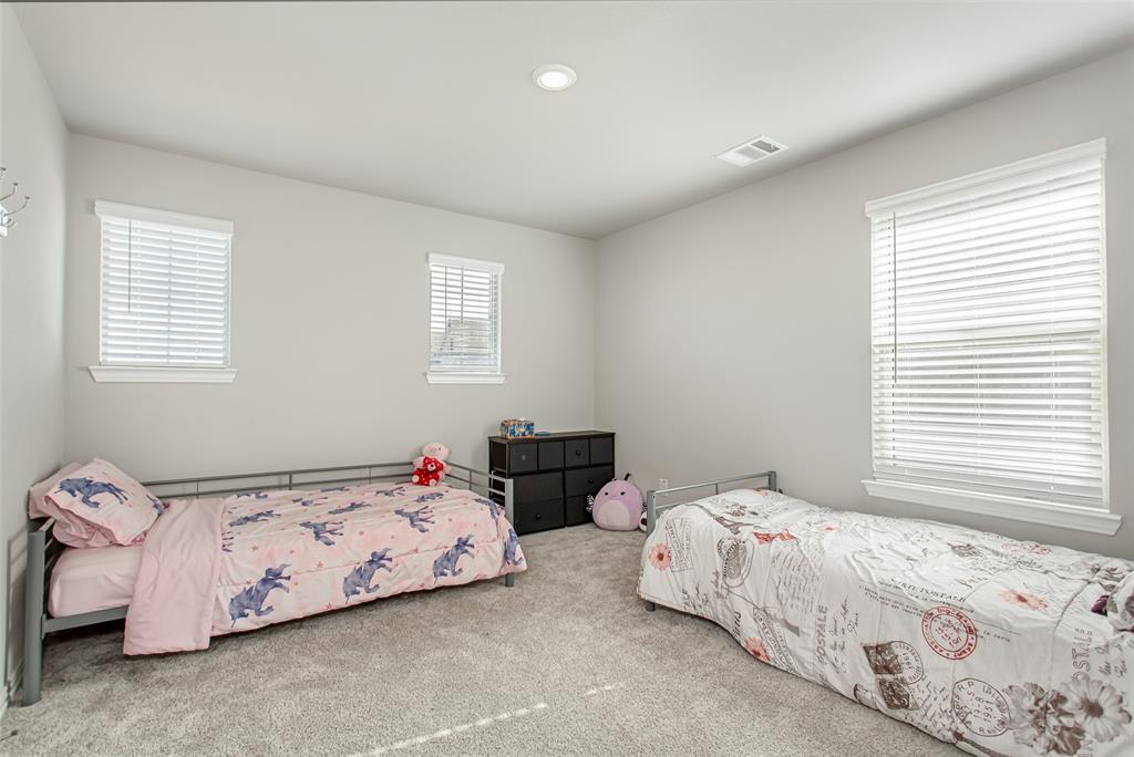 2437 Pinnacle Place Corinth, TX 76210 - Photo 33 of 40 a bedroom with two beds and a window