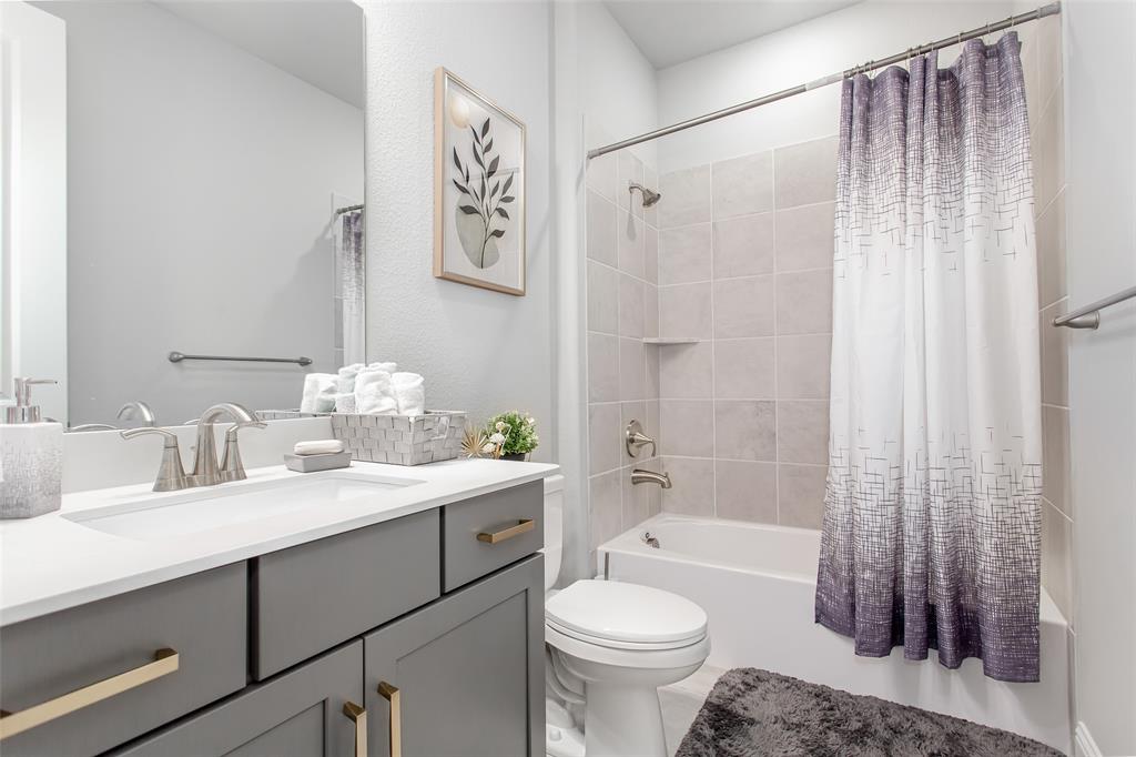 2437 Pinnacle Place Corinth, TX 76210 - Photo 6 of 40 a bathroom with a sink toilet and shower