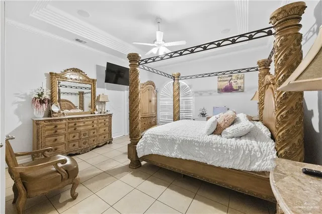 a bedroom with a bed dresser and window