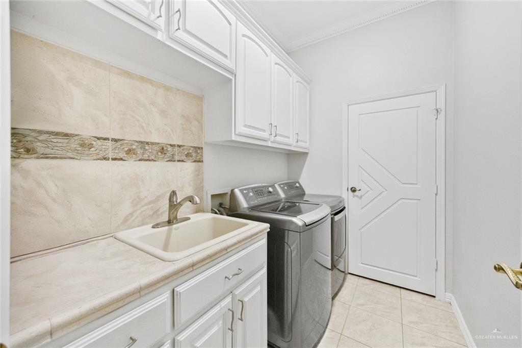 800 East Mile 3 Road Mission, TX 78573 - Photo 21 of 45 a kitchen with stainless steel appliances granite countertop a sink and a refrigerator