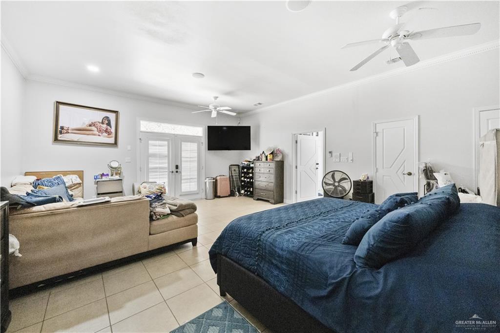 800 East Mile 3 Road Mission, TX 78573 - Photo 22 of 45 a large bedroom with a bed couches and flat screen tv