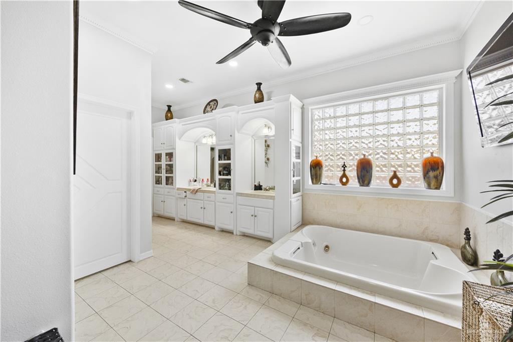 800 East Mile 3 Road Mission, TX 78573 - Photo 23 of 45 a en suite bathroom with a tub double vanity and a window