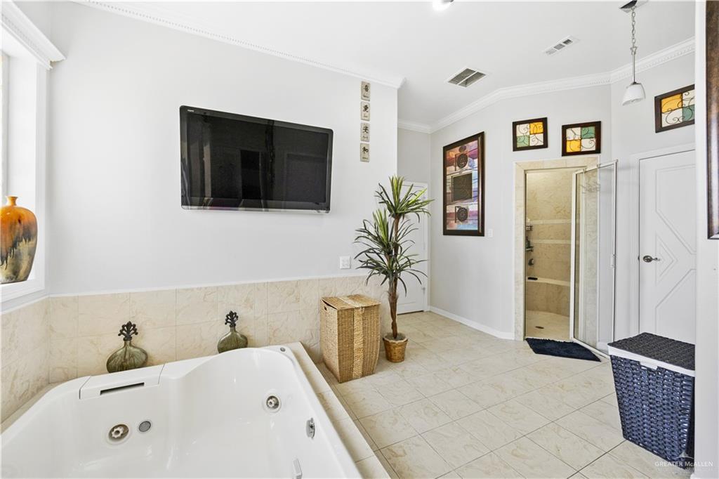 800 East Mile 3 Road Mission, TX 78573 - Photo 24 of 45 a en suite spacious bathroom with a tub sink and mirror
