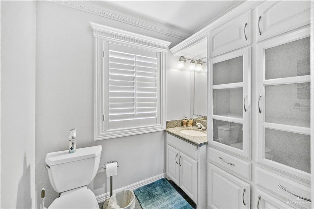 800 East Mile 3 Road Mission, TX 78573 - Photo 34 of 45 a bathroom with double vanity sink a mirror and a toilet