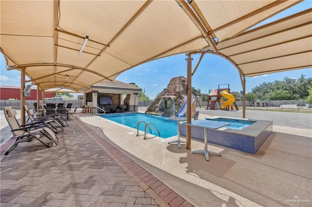 a view of a backyard with swimming pool