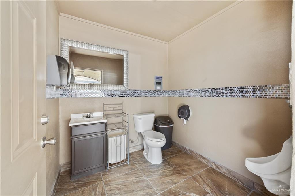 800 East Mile 3 Road Mission, TX 78573 - Photo 44 of 45 a bathroom with a toilet sink and mirror