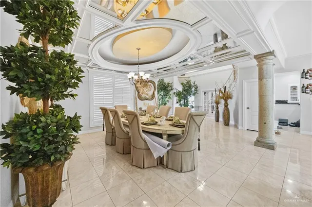 a view of a dining room with furniture and a potted plant