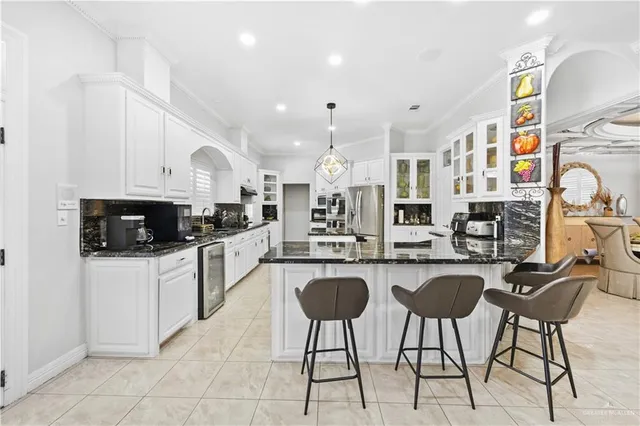 a kitchen with stainless steel appliances granite countertop a stove a sink a microwave and a refrigerator