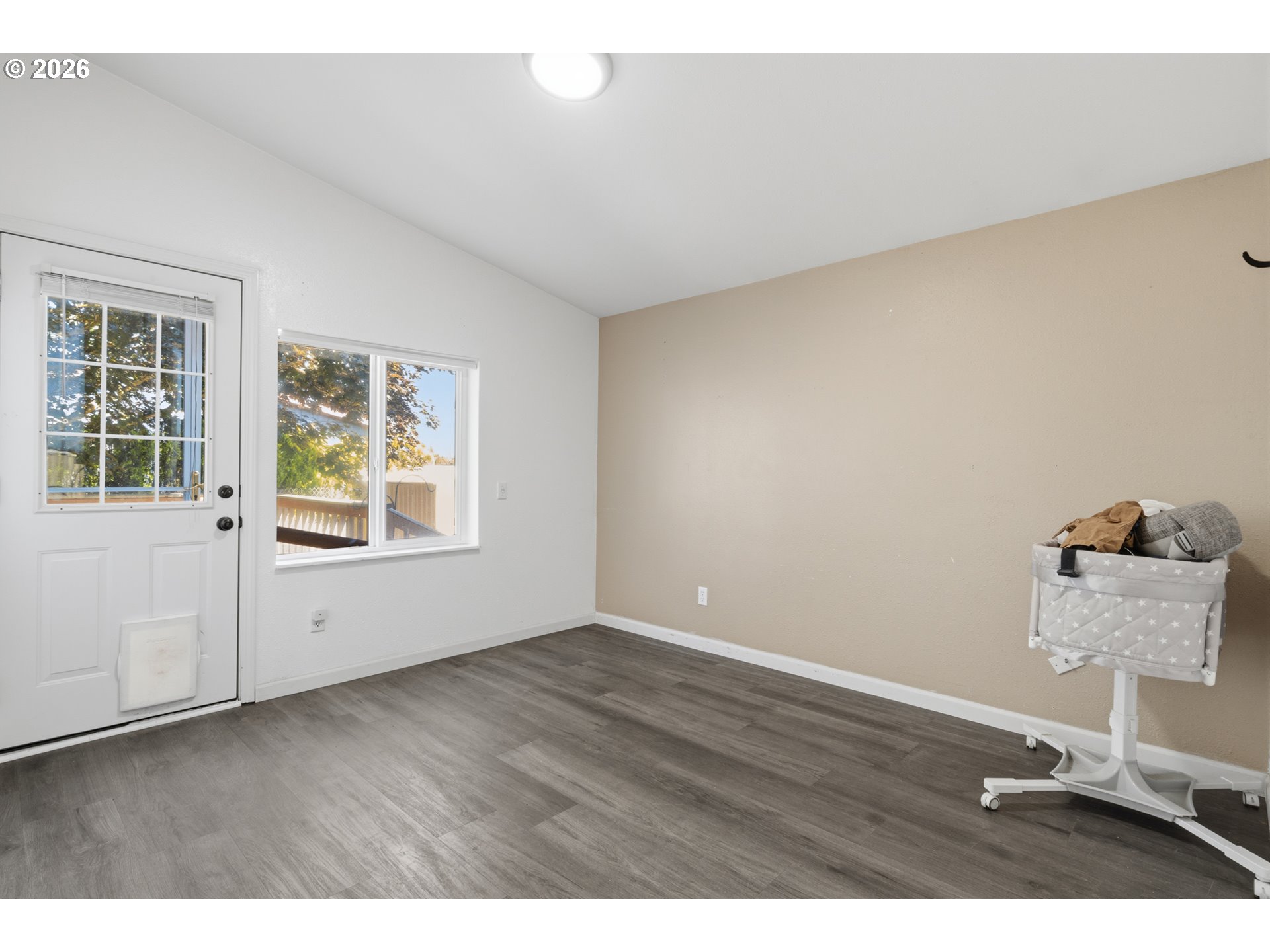 2151 Three Lakes Road Southeast Albany, OR 97322 - Photo 10 of 25 a view of an empty room with wooden floor and a window