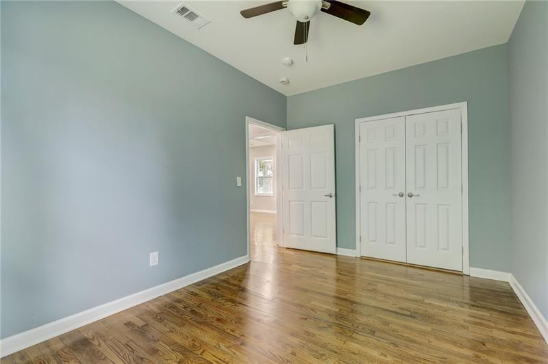 807 Gilbert Street Southeast Atlanta, GA 30316 - Photo 11 of 23 an empty room with wooden floor and ceiling fan