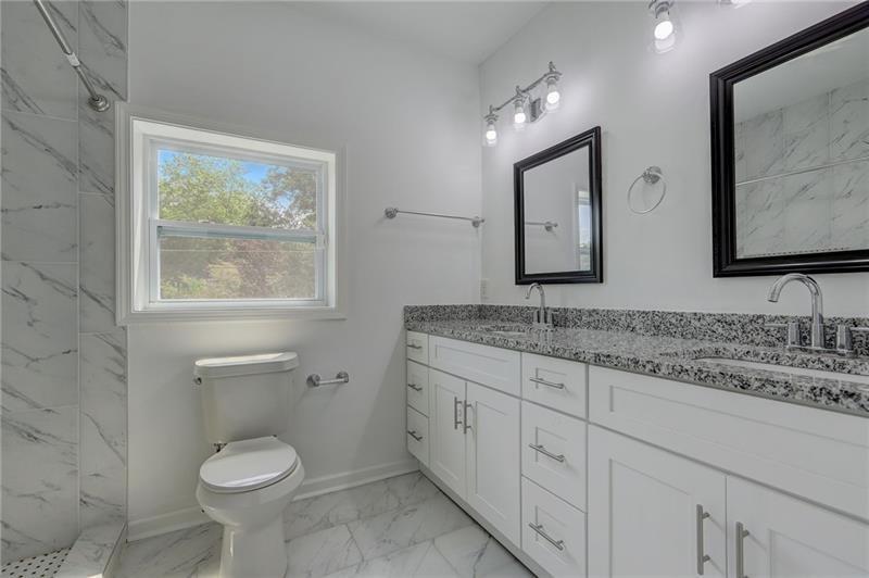 807 Gilbert Street Southeast Atlanta, GA 30316 - Photo 15 of 23 a bathroom with a granite countertop toilet sink and mirror