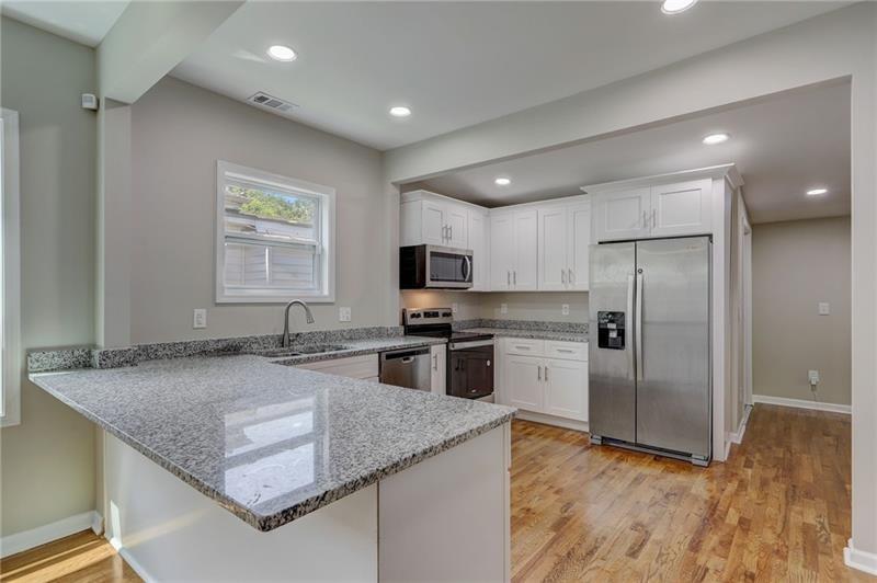 807 Gilbert Street Southeast Atlanta, GA 30316 - Photo 7 of 23 a kitchen with stainless steel appliances granite countertop a sink refrigerator and microwave