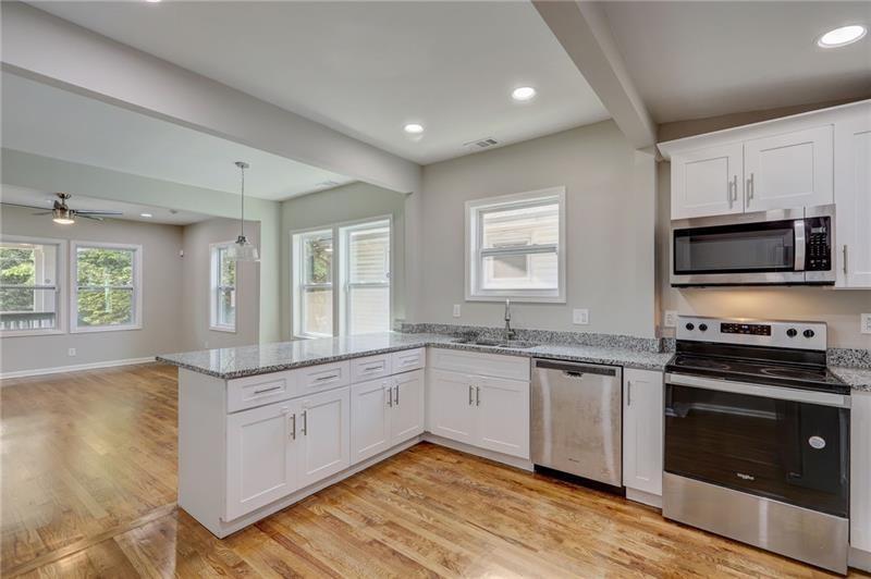 807 Gilbert Street Southeast Atlanta, GA 30316 - Photo 8 of 23 a kitchen with stainless steel appliances granite countertop a stove a sink and a microwave