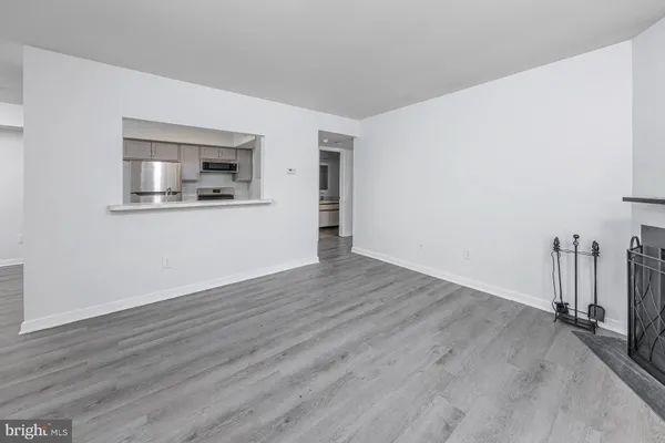 a view of a room with wooden floor and window