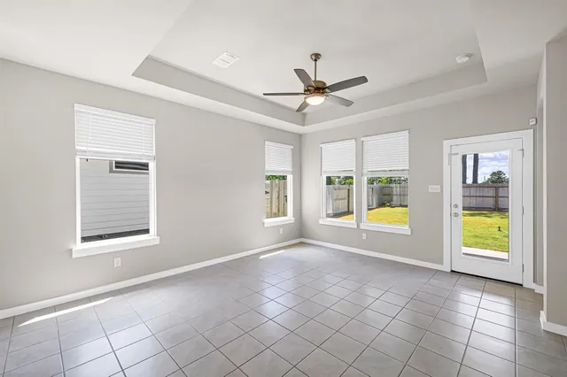 a view of an empty room and kitchen view