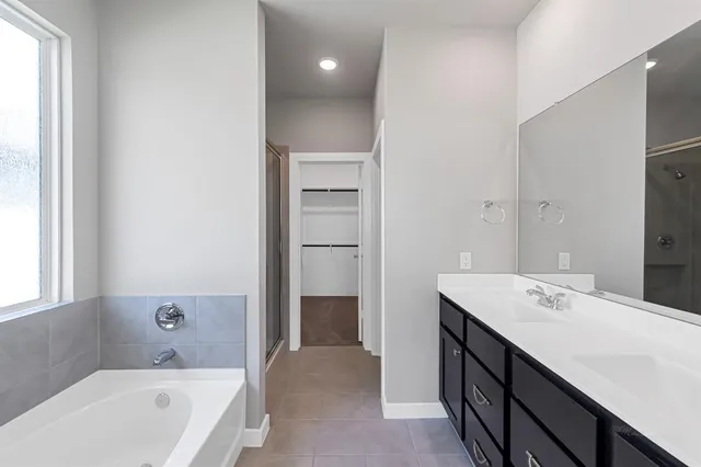 a bathroom with a sink double vanity and a mirror