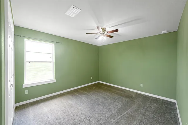 a view of a hallway with closet and wooden floor