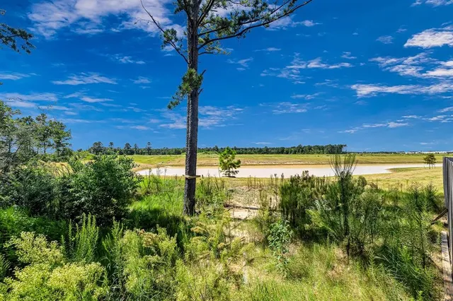 a front view of a house with a garden and yard