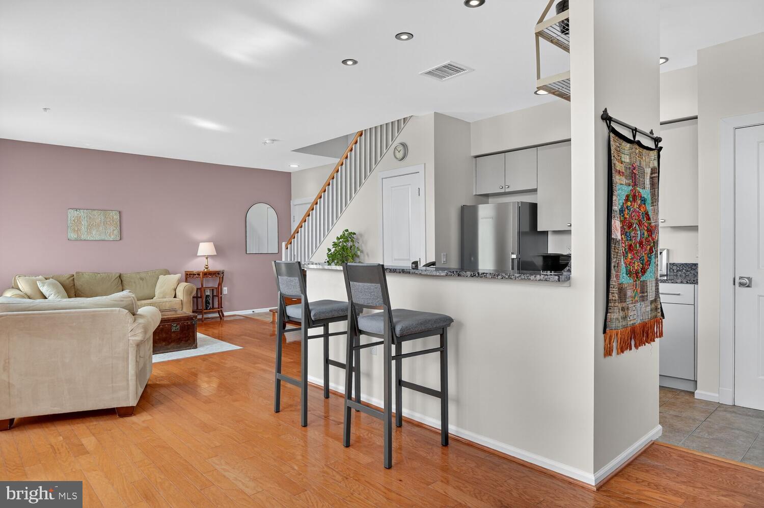 343 Cedar Street Northwest, Unit 322 Washington, DC 20012 - Photo 11 of 40 a living room with furniture and a wooden floor