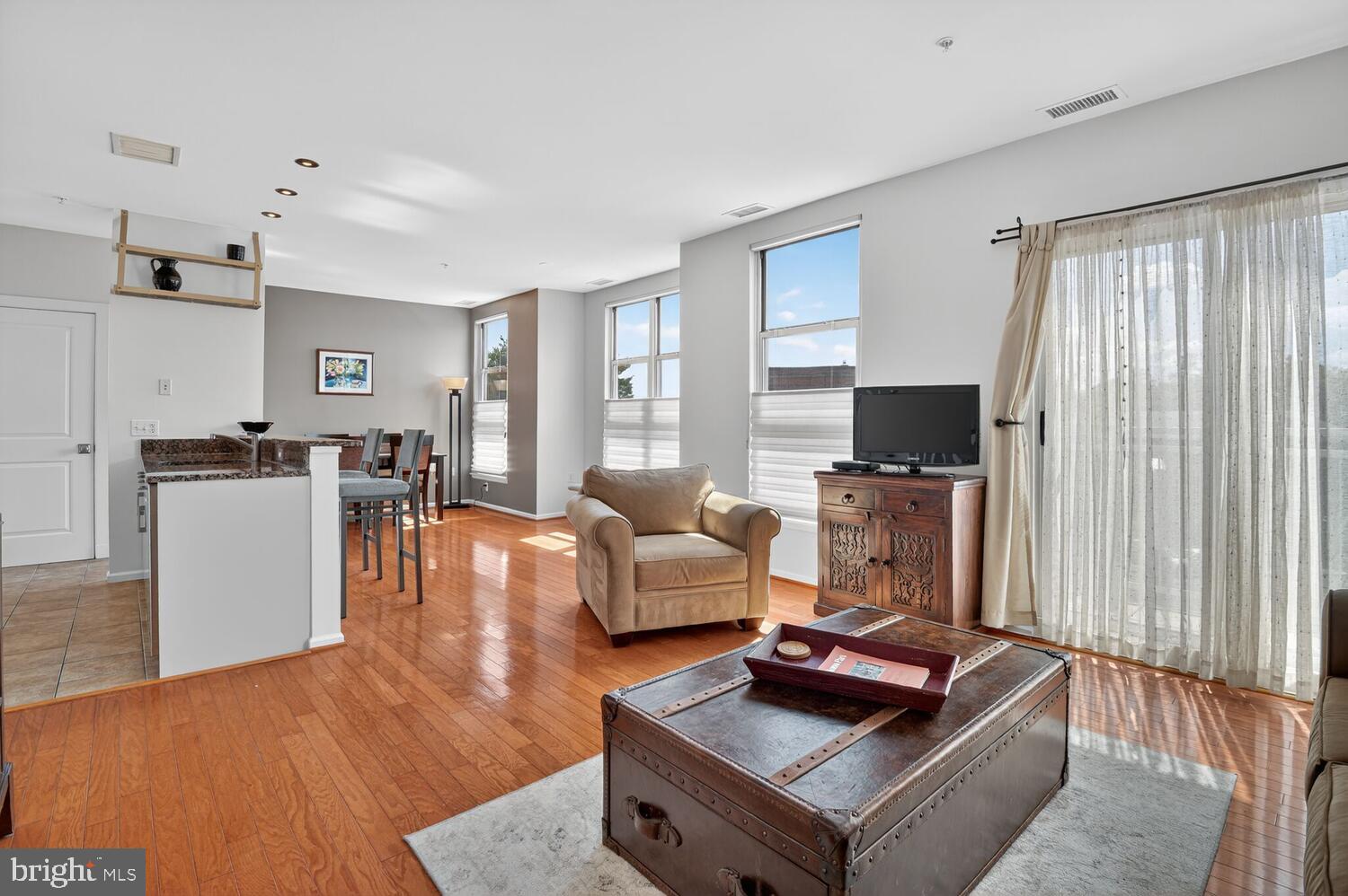 343 Cedar Street Northwest, Unit 322 Washington, DC 20012 - Photo 2 of 40 a living room with furniture and a flat screen tv