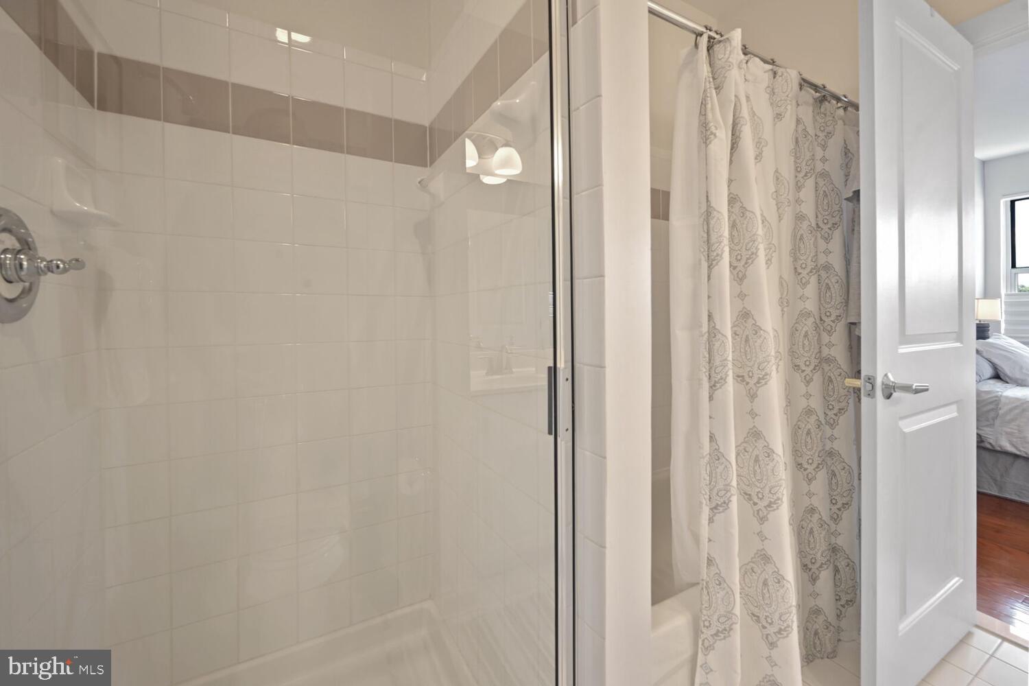 343 Cedar Street Northwest, Unit 322 Washington, DC 20012 - Photo 26 of 40 a bathroom with a shower and a curtain