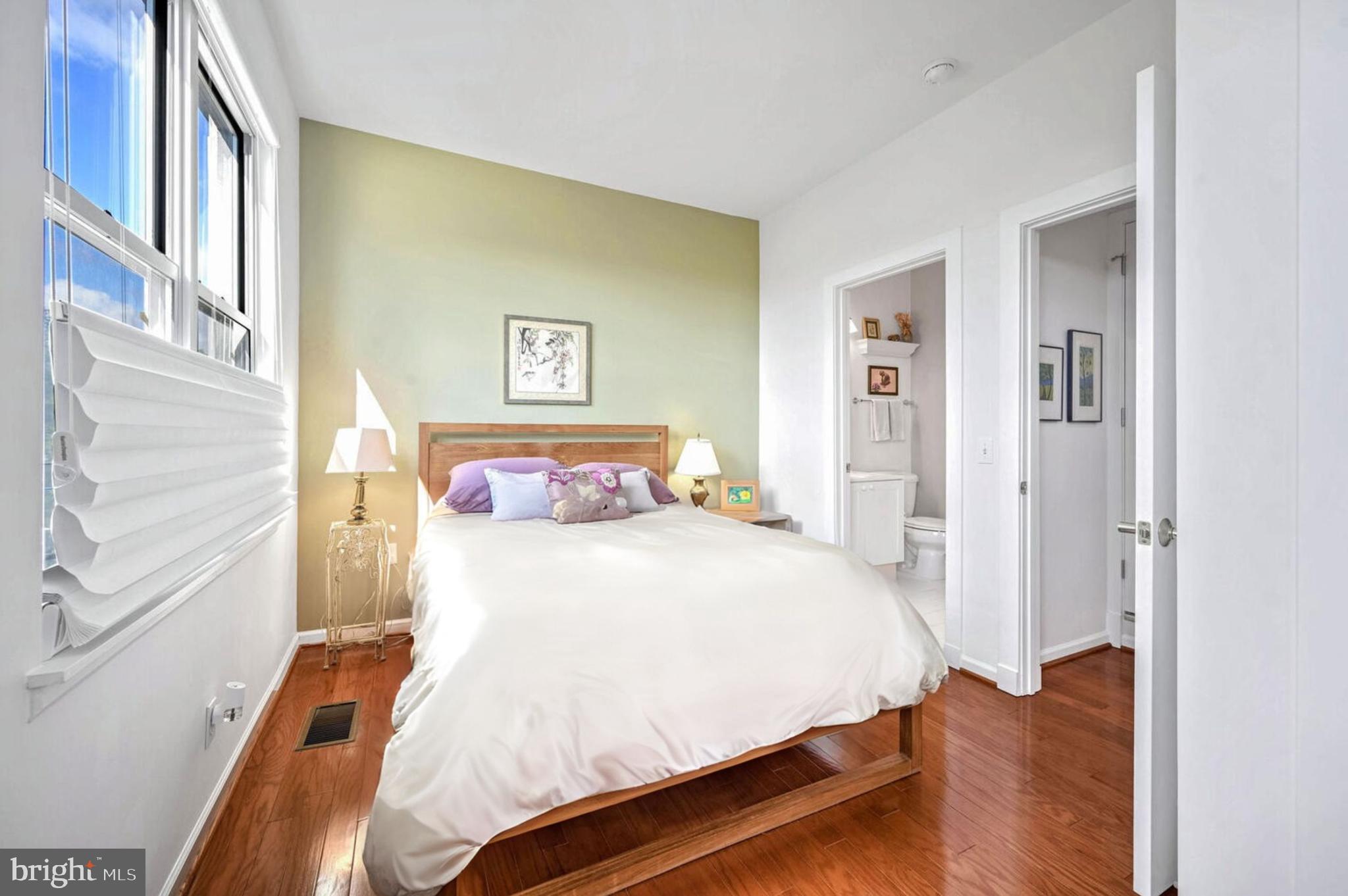 343 Cedar Street Northwest, Unit 322 Washington, DC 20012 - Photo 30 of 40 a bedroom with a bed and a painting on the wall