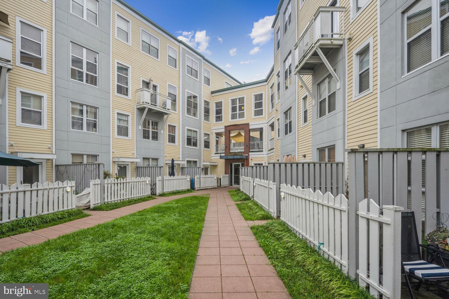 343 Cedar Street Northwest, Unit 322 Washington, DC 20012 - Photo 38 of 40 a view of a brick building next to a yard