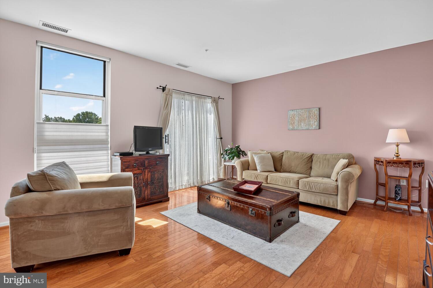 343 Cedar Street Northwest, Unit 322 Washington, DC 20012 - Photo 5 of 40 a living room with furniture flat screen tv and a large window