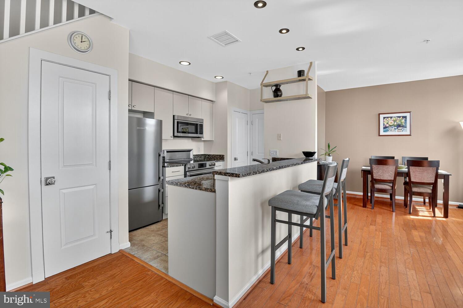 343 Cedar Street Northwest, Unit 322 Washington, DC 20012 - Photo 7 of 40 a view of kitchen with refrigerator and wooden floor